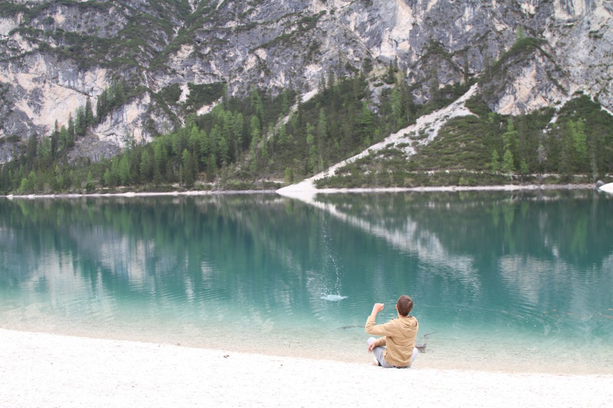 Skipping rocks at Pragersee Lake in the Dolomites.